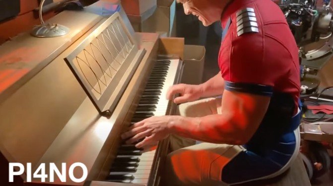 John Cena playng piano at Peacemaker set